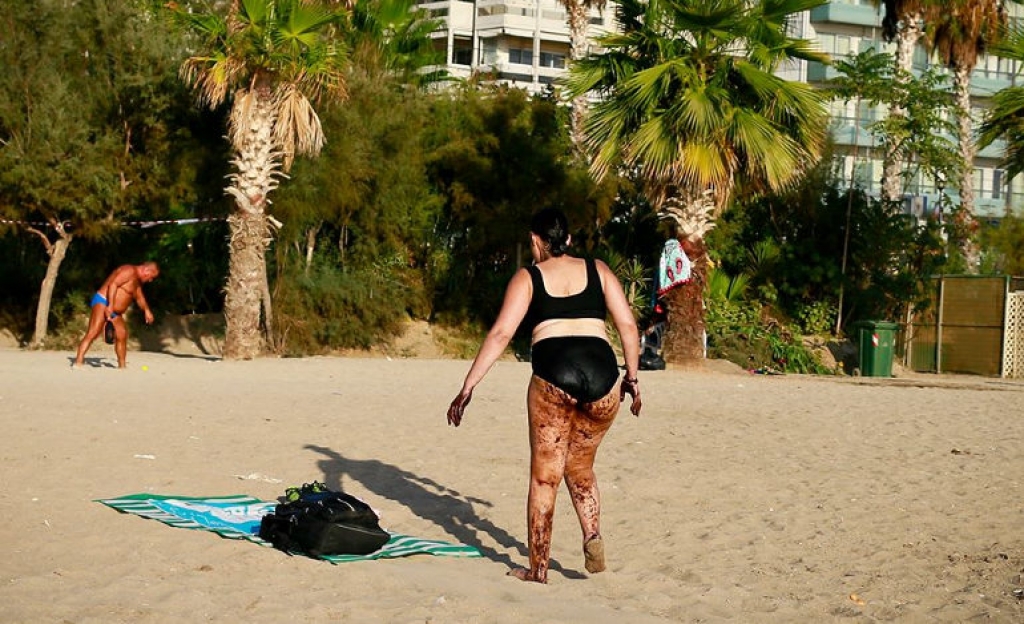 Φωτογραφία που σοκάρει: Γυναίκα βγαίνει από τη θάλασσα του Π. Φαλήρου καλυμμένη με πίσσα